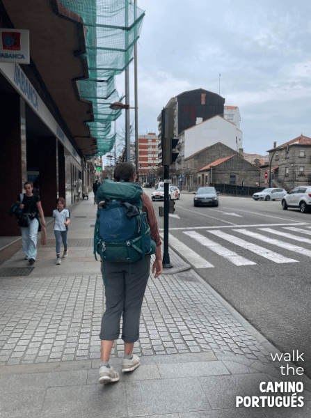 Pilgrim walking on a busy street in Vigo on the Portuguese Camino da Costa
